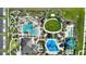 Aerial view of the community pool, water park, and recreation area with shaded seating and plenty of green space at 1423 Bunker Dr, Davenport, FL 33896