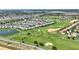 Aerial view of the property's location on a golf course, near a pond, indicated by the red pin at 1423 Bunker Dr, Davenport, FL 33896