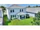 Overhead shot of a property featuring a well-kept lawn, inviting backyard, and a modern exterior design at 1423 Bunker Dr, Davenport, FL 33896