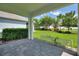 Covered patio area with scenic view of the manicured lawn and green landscape at 1423 Bunker Dr, Davenport, FL 33896