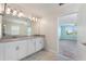 Bright bathroom with dual sinks and a view of the bedroom at 1423 Bunker Dr, Davenport, FL 33896