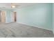 A spacious bedroom with neutral carpet, a ceiling fan, and ensuite bathroom entry at 1423 Bunker Dr, Davenport, FL 33896