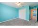 Bright bedroom with neutral carpet, ceiling fan, and closet at 1423 Bunker Dr, Davenport, FL 33896