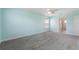 A bright bedroom with neutral carpet, ceiling fan, and ensuite bathroom at 1423 Bunker Dr, Davenport, FL 33896