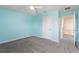 Bright bedroom with neutral carpet, ceiling fan, and ensuite bathroom entry at 1423 Bunker Dr, Davenport, FL 33896