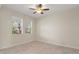 Bedroom boasts tile floors, a ceiling fan, and views of the outdoors at 1423 Bunker Dr, Davenport, FL 33896