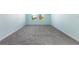 Bright bedroom with neutral carpet and two windows overlooking a treed landscape at 1423 Bunker Dr, Davenport, FL 33896