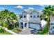 Stunning two-story home showcasing lush landscaping, a paved driveway, and a two-car garage at 1423 Bunker Dr, Davenport, FL 33896