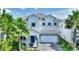 Beautiful two-story home with a manicured lawn, paved driveway, and a striking blue front door at 1423 Bunker Dr, Davenport, FL 33896