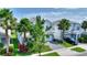 Attractive two-story home featuring a paved driveway, well-maintained lawn, and mature trees at 1423 Bunker Dr, Davenport, FL 33896