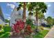 Beautiful two-story home showcasing tropical landscaping, a paved driveway, and a well-manicured lawn at 1423 Bunker Dr, Davenport, FL 33896