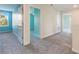 Bright hallway with neutral carpet and access to multiple rooms with coordinated color schemes at 1423 Bunker Dr, Davenport, FL 33896