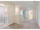 Spacious hallway with multiple rooms and access to the laundry room at 1423 Bunker Dr, Davenport, FL 33896