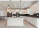 Modern kitchen with white cabinets, gray countertops, and stainless steel appliances at 1423 Bunker Dr, Davenport, FL 33896