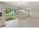 Spacious living room boasting tiled floors, recessed lighting, and outdoor views at 1423 Bunker Dr, Davenport, FL 33896