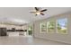 Bright living room features tile flooring, large windows, and an open floor plan at 1423 Bunker Dr, Davenport, FL 33896