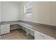 Bright home office featuring custom built-in desk, ample countertop space, and storage, perfect for remote work at 1423 Bunker Dr, Davenport, FL 33896