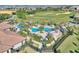 Aerial shot showcasing a pool and palm trees next to a golf course in a residential community at 1423 Bunker Dr, Davenport, FL 33896