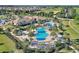 A community pool area features lush landscaping and comfortable lounge seating with mature palm trees at 1423 Bunker Dr, Davenport, FL 33896