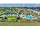 A Gathering-friendly neighborhood waterpark with multiple pools and slides surrounded by palm trees at 1423 Bunker Dr, Davenport, FL 33896