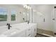 Modern bathroom features a glass shower, large vanity, and dual sinks at 216 E Harding St, Orlando, FL 32806