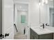 Bathroom features a modern vanity with black faucet and wood look floors at 216 E Harding St, Orlando, FL 32806