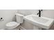 Contemporary half-bath with a pedestal sink and toilet at 216 E Harding St, Orlando, FL 32806