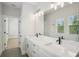 Modern bathroom features a dual sink vanity, sleek fixtures, and tile floor at 216 E Harding St, Orlando, FL 32806