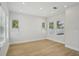 Bright bedroom featuring sleek hardwood floors, recessed lighting, and large windows at 216 E Harding St, Orlando, FL 32806
