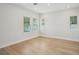 Well-lit bedroom showcasing sleek hardwood floors, recessed lighting, and bright windows at 216 E Harding St, Orlando, FL 32806