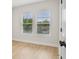 Bright bedroom featuring sleek hardwood floors, neutral walls, and large windows at 216 E Harding St, Orlando, FL 32806