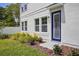 Charming home featuring a bright blue front door and manicured landscaping at 216 E Harding St, Orlando, FL 32806
