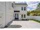 Stunning exterior of a bright, modern home featuring a blue door and two-car garage at 216 E Harding St, Orlando, FL 32806