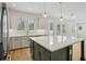 Bright eat-in kitchen with stainless steel appliances, pendant lighting, and large center island at 216 E Harding St, Orlando, FL 32806