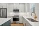 Beautiful modern kitchen featuring white cabinets and stainless steel appliances at 216 E Harding St, Orlando, FL 32806