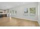Bright living room area with hardwood floors and many windows bringing in natural light at 216 E Harding St, Orlando, FL 32806
