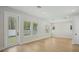Open concept living room with hardwood floors and large windows at 216 E Harding St, Orlando, FL 32806