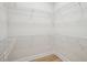 Spacious walk-in closet featuring white wire shelving and modern flooring at 216 E Harding St, Orlando, FL 32806