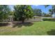 View of the exterior screened-in patio, mature landscaping and fenced in backyard at 3115 Lake Arnold Pl, Orlando, FL 32806
