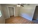 An empty bedroom with a ceiling fan and wood-look flooring, plus a closet at 3115 Lake Arnold Pl, Orlando, FL 32806