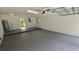 Spacious two car garage with concrete block walls and a side entrance door at 3115 Lake Arnold Pl, Orlando, FL 32806