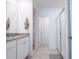 Clean bathroom featuring double sinks, modern granite countertops, white cabinets, and a glass-enclosed shower at 573 Vista Villages Blvd, Davenport, FL 33896
