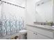 Bathroom featuring granite countertops, white vanity, and decorative details at 573 Vista Villages Blvd, Davenport, FL 33896