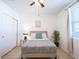 Well-lit bedroom featuring a ceiling fan, closet, and large window at 573 Vista Villages Blvd, Davenport, FL 33896