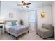 Relaxing bedroom with a seating area and natural light from the window at 573 Vista Villages Blvd, Davenport, FL 33896