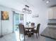 Inviting dining area features a stylish table, elegant lighting, and a view of the backyard through sliding glass doors at 573 Vista Villages Blvd, Davenport, FL 33896