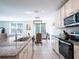 Bright kitchen featuring stainless steel appliances, granite countertops, and a seamless open-concept design at 573 Vista Villages Blvd, Davenport, FL 33896