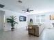 Spacious living room features a comfortable sofa, a large television, and stylish decor elements for a cozy and inviting atmosphere at 573 Vista Villages Blvd, Davenport, FL 33896