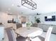 Bright and airy living space features a dining table, modern kitchen, and comfortable living area, perfect for Gathering gatherings at 573 Vista Villages Blvd, Davenport, FL 33896