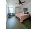 Cozy bedroom with ceiling fan, closet, and natural light from large window at 85 Heather Point Ct # 850, New Smyrna Beach, FL 32169